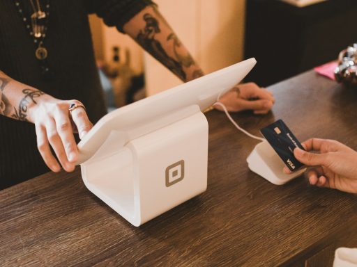 person holding white POS machine