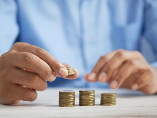 a person stacking coins on top of a table