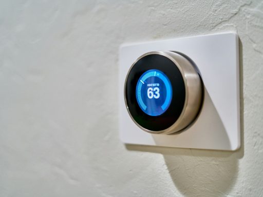 gray Nest thermostat displaying at 63