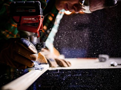 person holding orange and black power tool