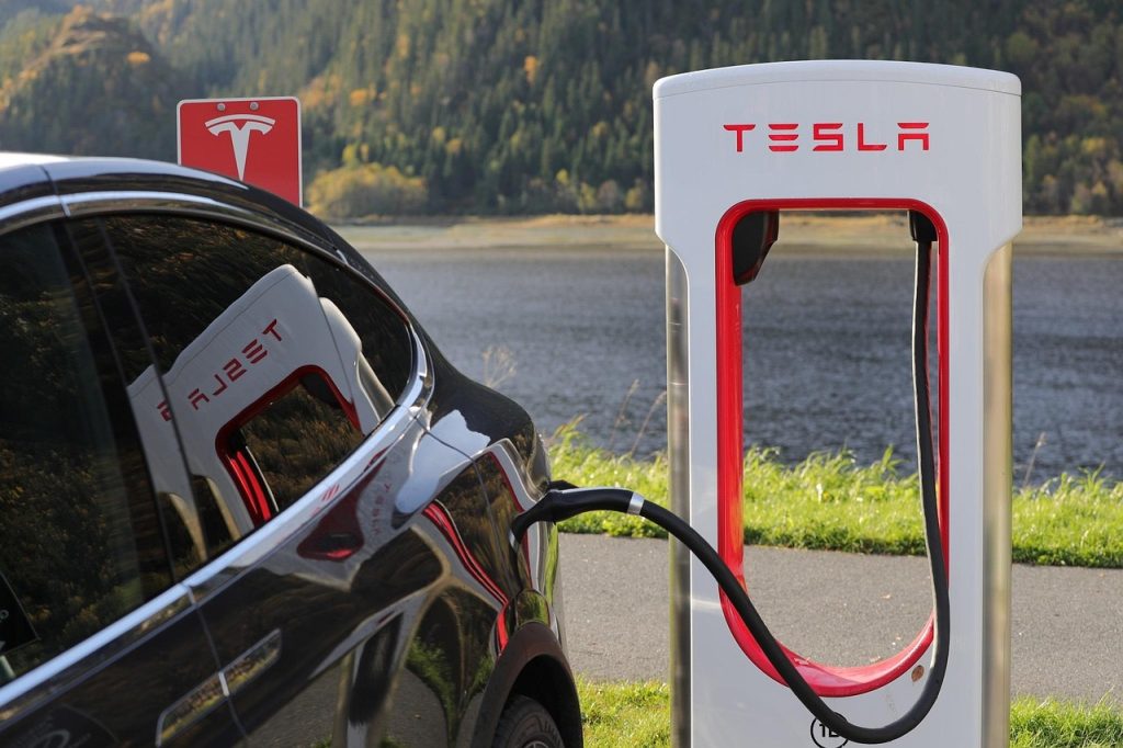 Elektrische wagen die oplaadt aan een thuislaadpaal bij een Belgische woning