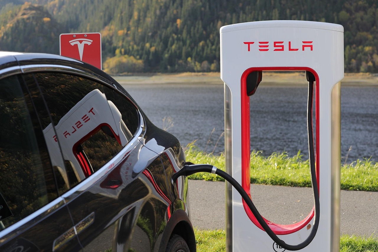 Elektrische wagen die oplaadt aan een thuislaadpaal bij een Belgische woning